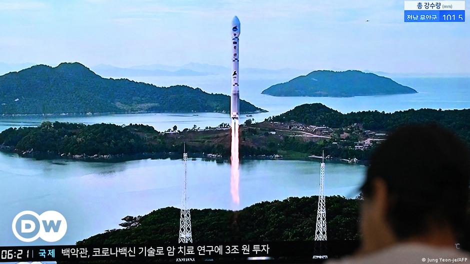 Ukrainian servicemen ride a tank on a road near the village of Robotyne