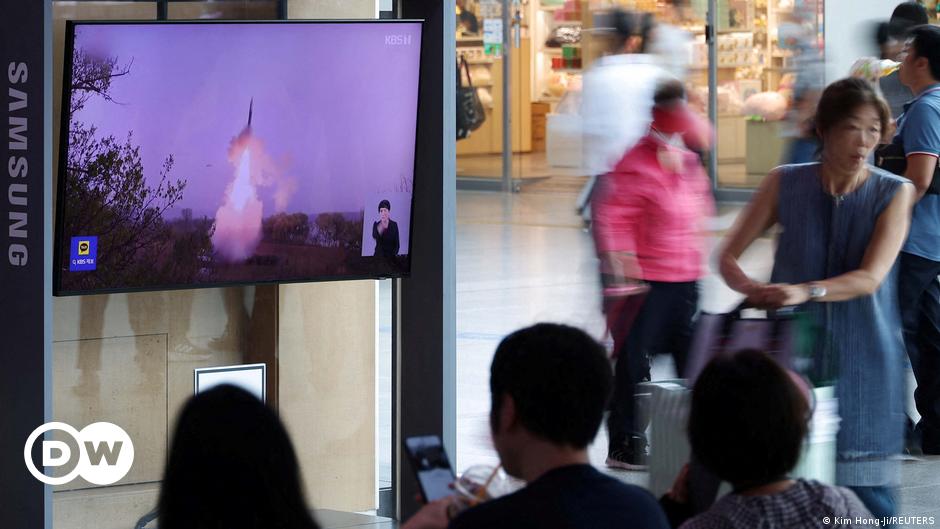 A soldier watches through binoculars from his shelter at the front line near Bakhmut, Ukraine, on August 30