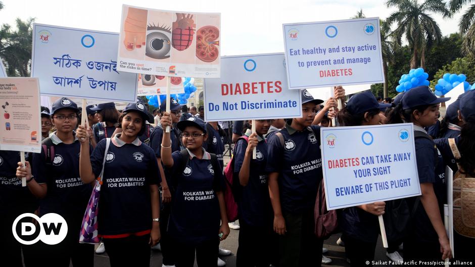 A Pakistani man with diabetes checks his blood sugar level