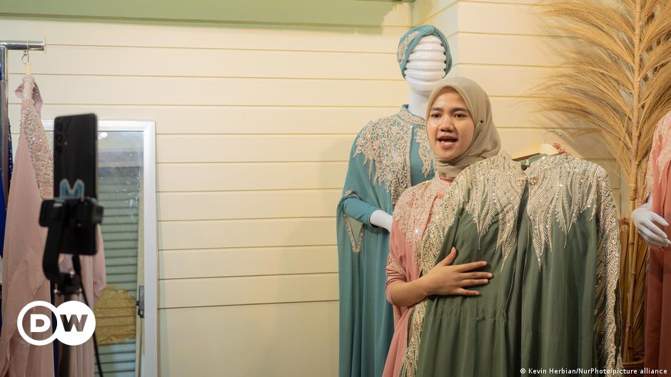 Cars and men against a mountainous backdrop