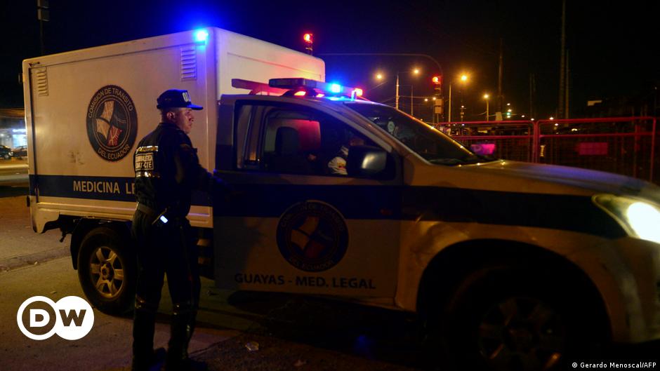 Three people look around a demolished street after Gaza rocket launches