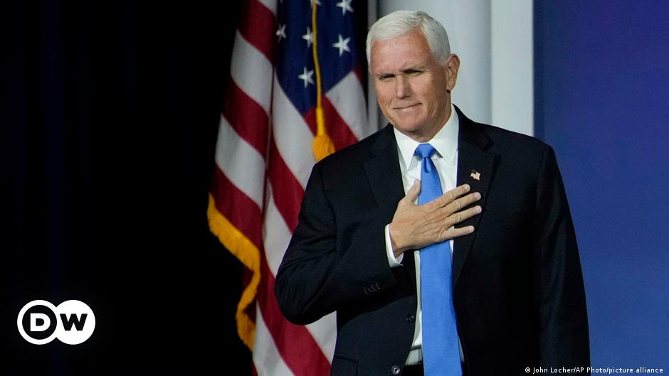 Mike Pence holding a microphone and pointing with his index finger as he speaks