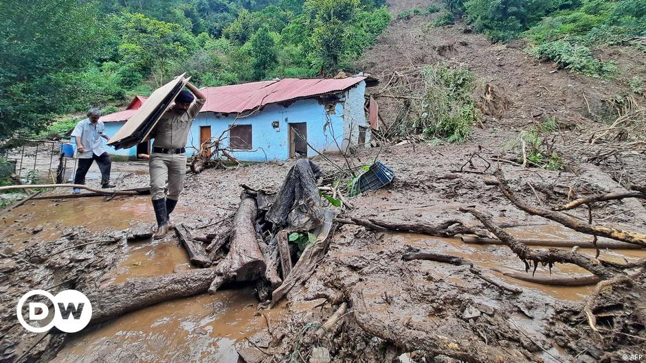 Two women cover their heads on a hot day