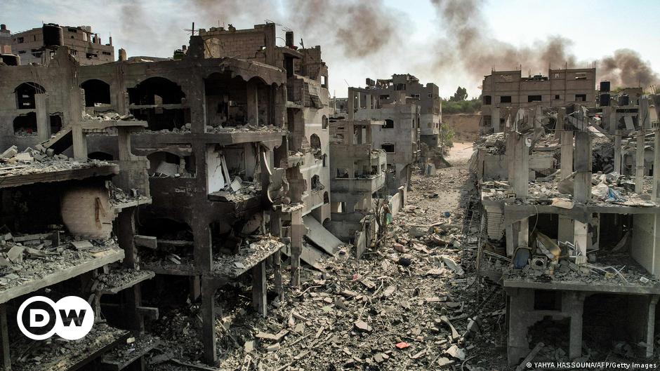 A woman in Tel Aviv praying before candles lit in memory of those killed and for the hostages