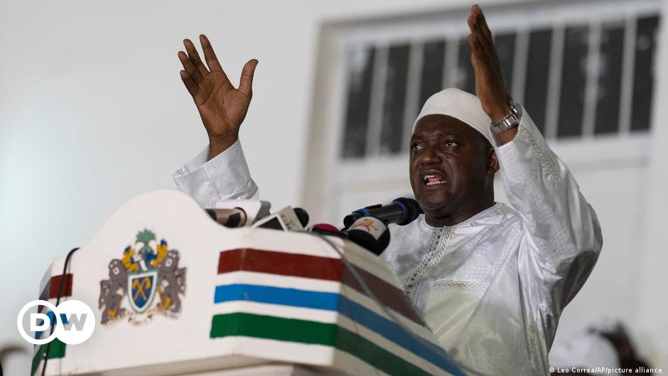 Yahya Jammeh points to the camera as soldiers look on in a picture from 2016