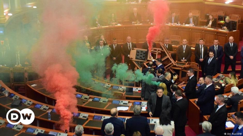 Migrants walk over the mountainous border between Greece and Albania