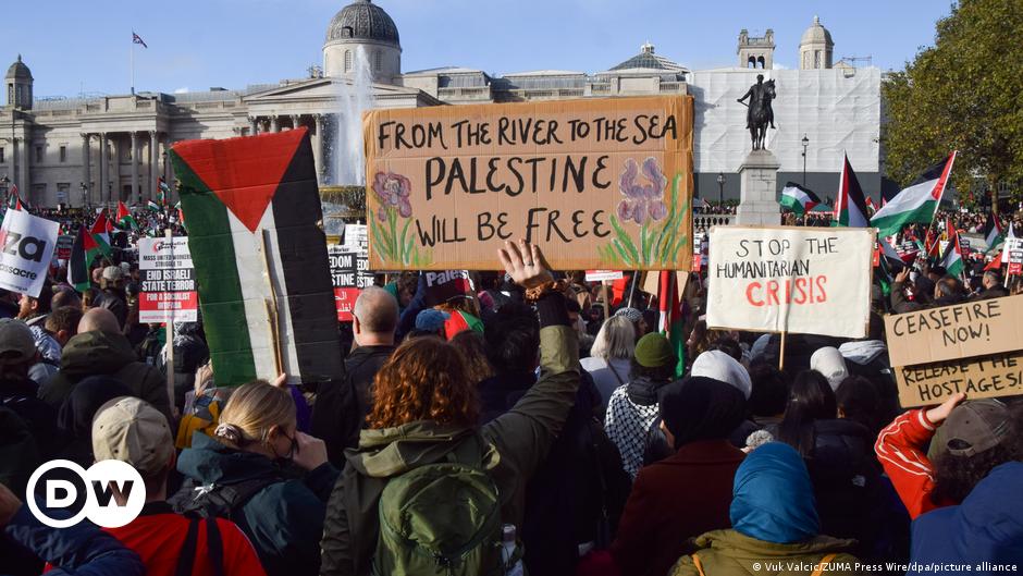 A Palestinian woman holds a key during a march to commemorate the 74th anniversary of the ''Nakba'' in Gaza City