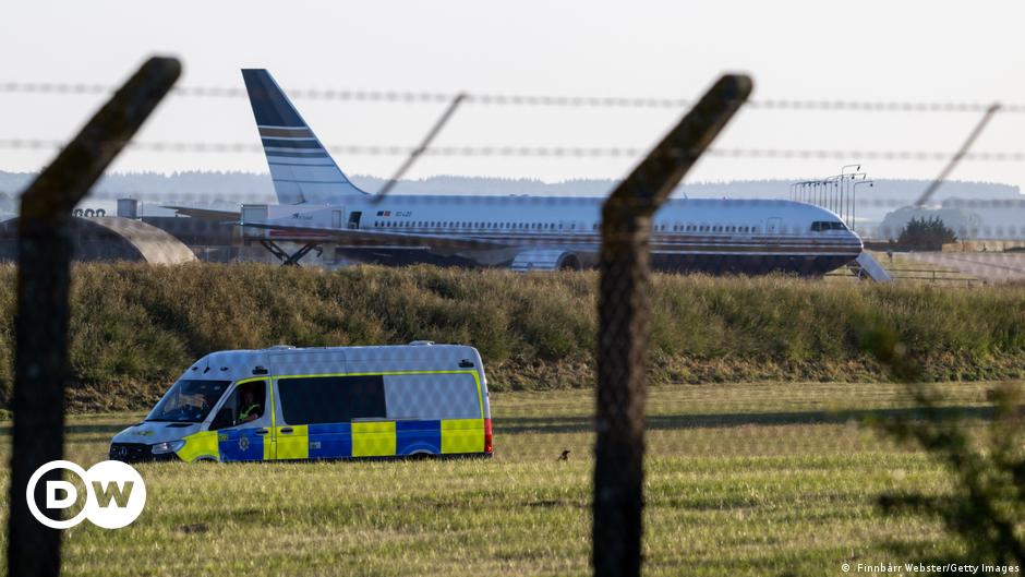 A group of migrants standing around their belongings