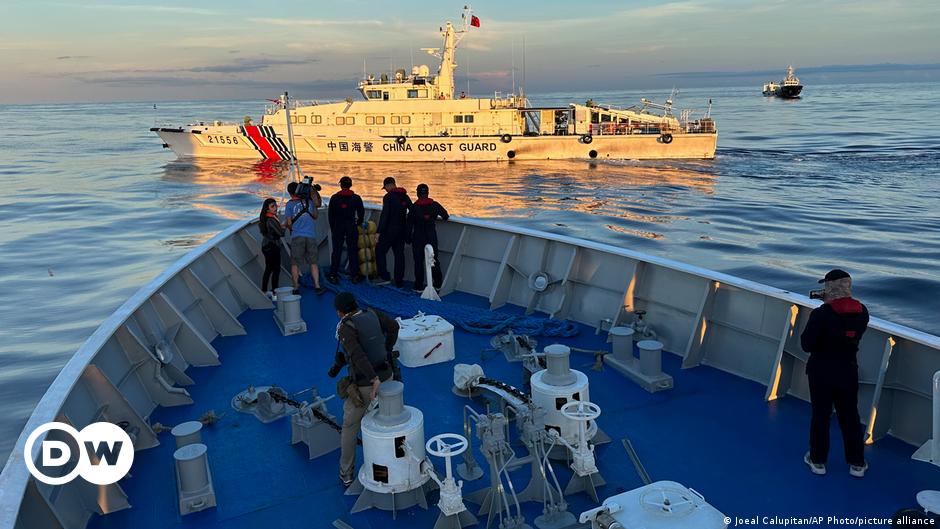 Aerial view of a Chinese naval militia vessel on patrol near the Chinese-controlled Scarborough Shoal, as a Philippine fishing boat is seen anchored nearby