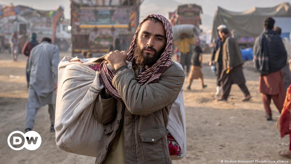 Male Afghan refugee carrying belongings