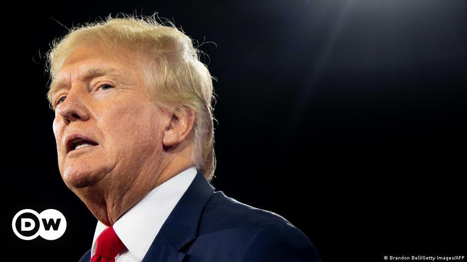 Donald Trump dressed in a suit and tie gesticulates in a New York court