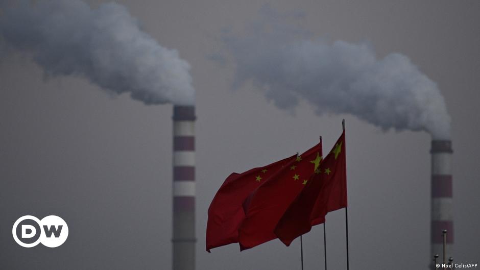 John Kerry (left) shakes hands with China's Xie Zhenhua before climate talks in Beijing