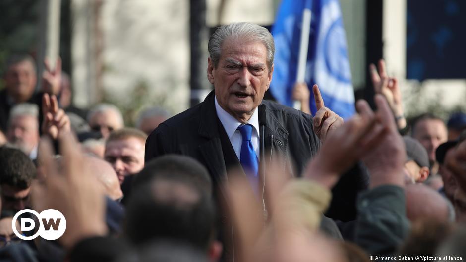 Workers install a large banner reading 'EU-Western Balkans Summit' in Brussels, Belgium
