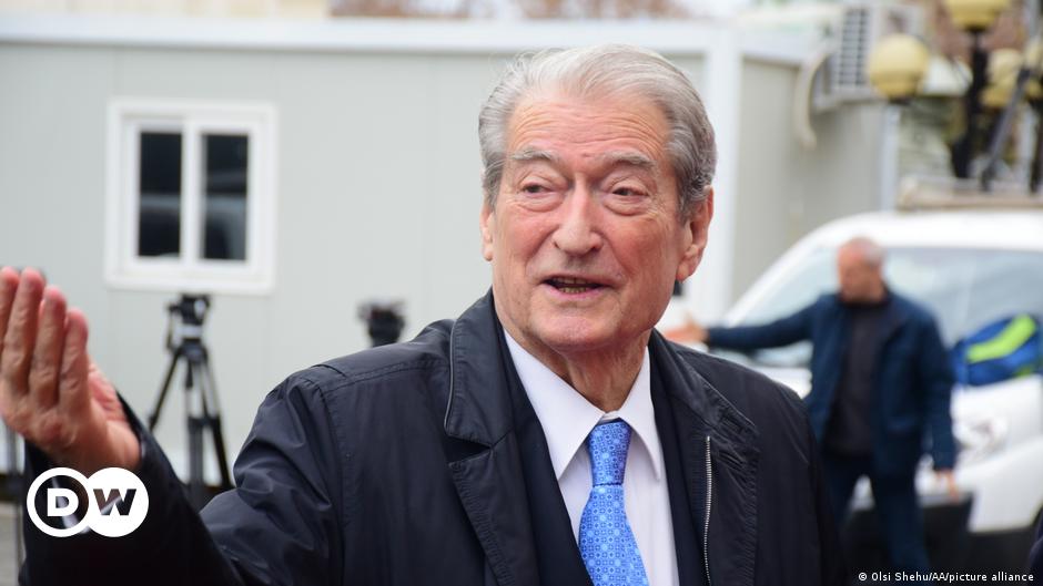 Workers install a large banner reading 'EU-Western Balkans Summit' in Brussels, Belgium