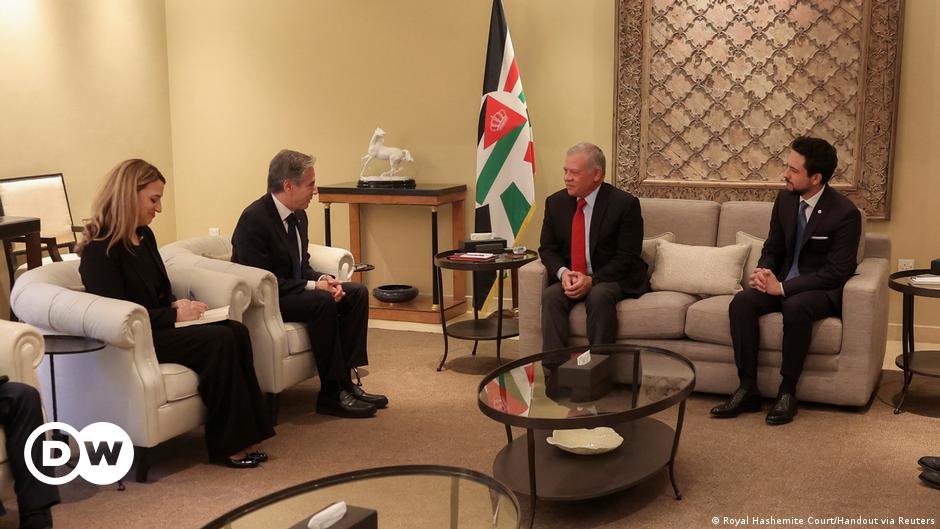 Jean-Pierre Lacroix, in glasses and coat and tie, sits in a chair and looks at the camera
