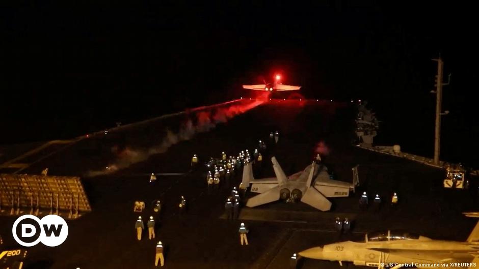 Jean-Pierre Lacroix, in glasses and coat and tie, sits in a chair and looks at the camera