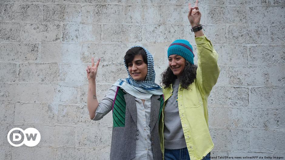 A female member of the Iranian police special force monitors an area, with only her eyes visible