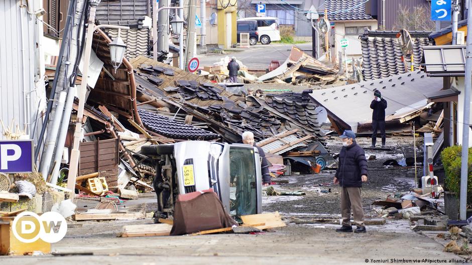 Harue Motoi, whose parents and younger brother died in 2011, prays in front of their grave