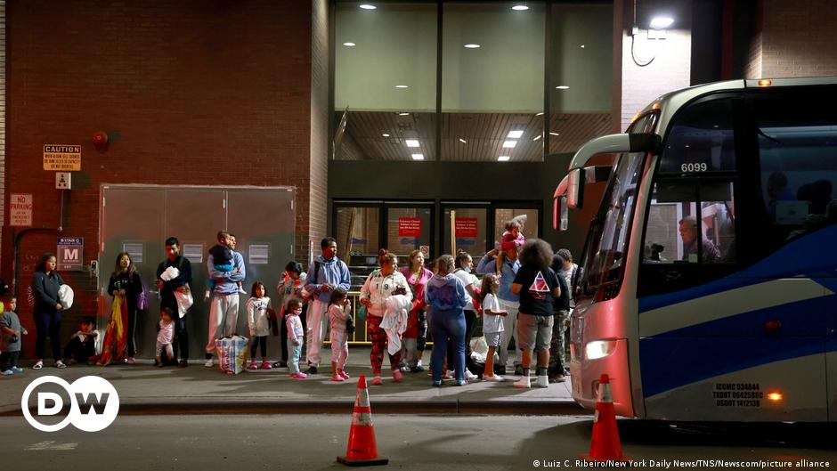 A group of migrants cross through the banks of the Rio Grande to the US