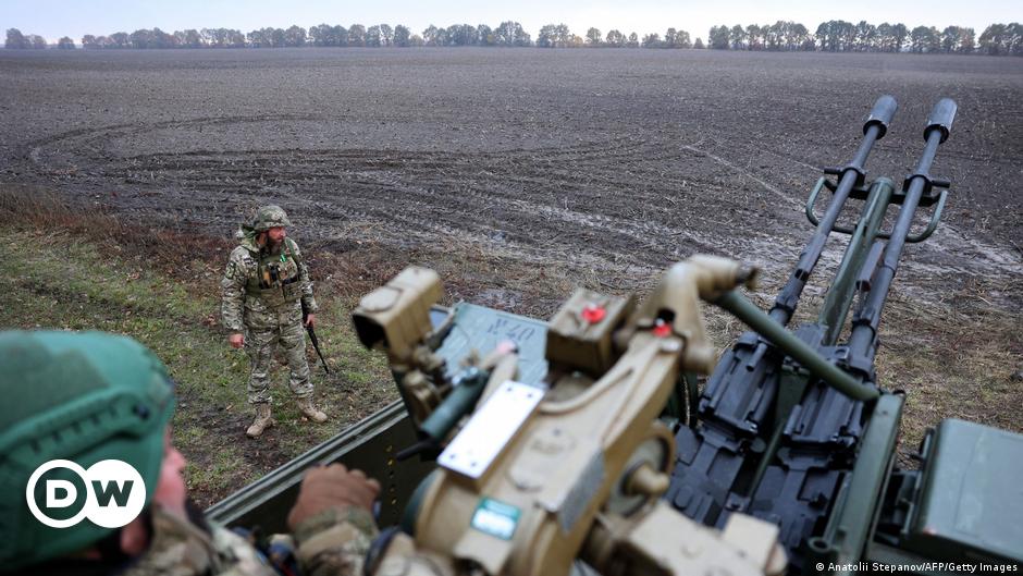 Ukrainian service members inspect a damaged Russia's tank T-72 BV