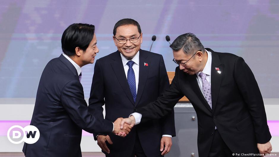 A military helicopter formation flying over Taipei carrying a Taiwanese flag