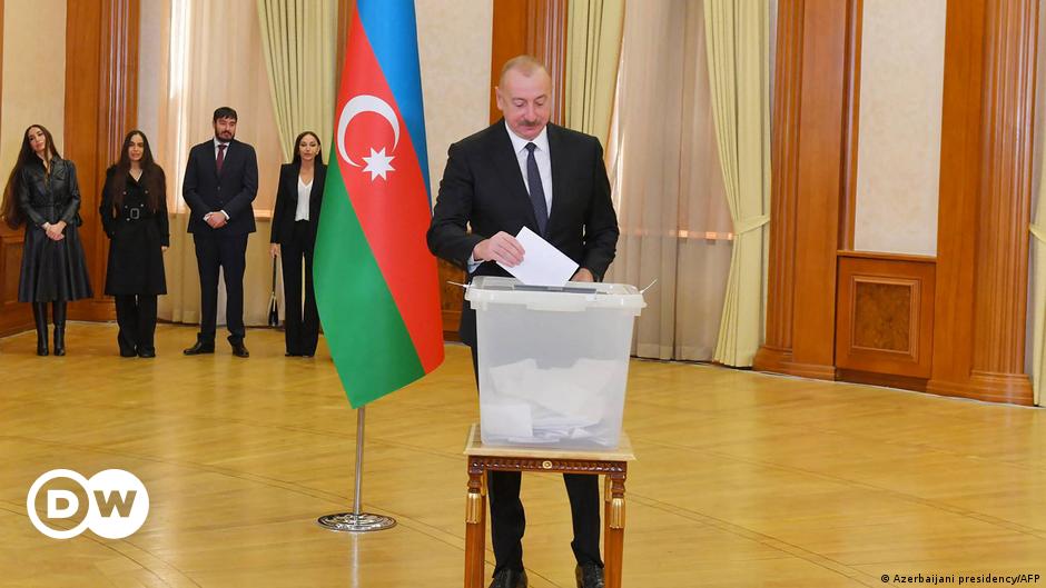 Police officers restrain an angry crowd