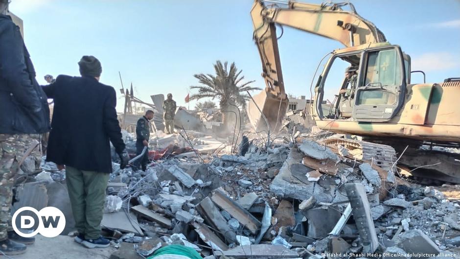 Family members of Iranian colonel Hassan Sayyad Khodaei weep over his body in his car after he was shot in Tehran