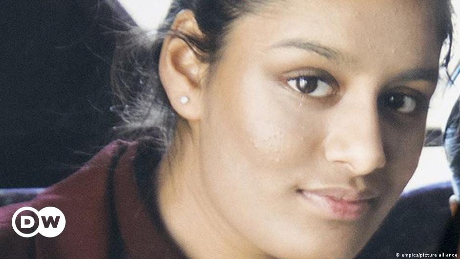 Women in abayas and a boy walk through Camp Roj near al-Malikiyah (Derik), Syria