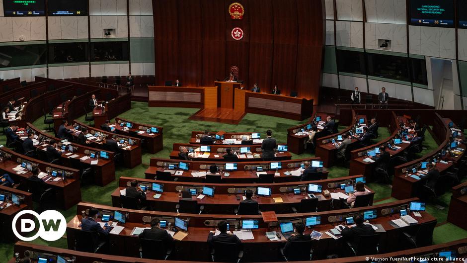 Photographers take picture of the members of League of Social Democrats scuffling with police outside the West Kowloon Magistrates