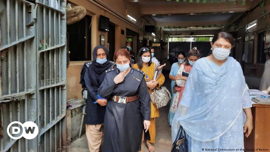 A young woman kneels while making bread