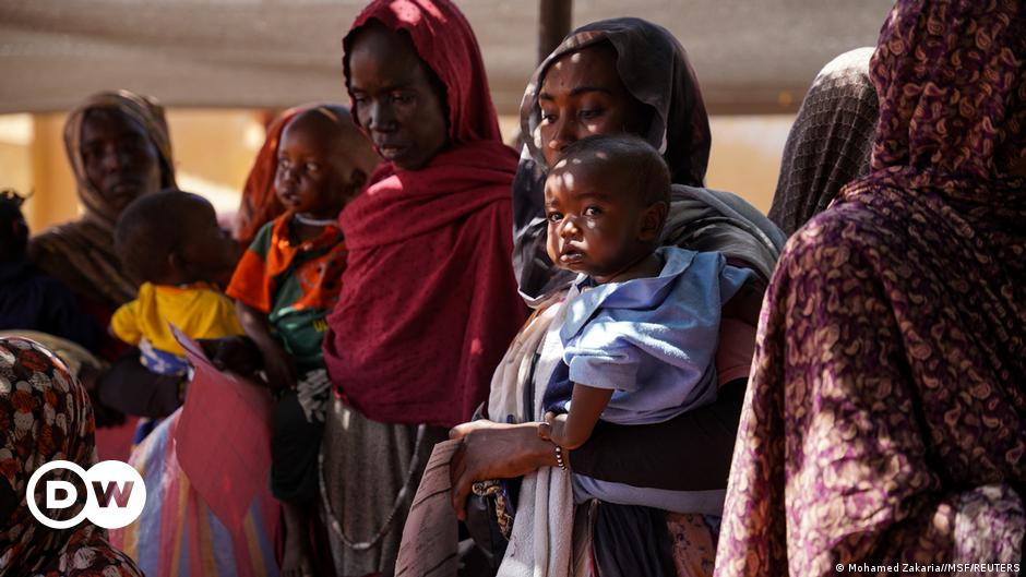 Sudanese refugees ride donkeys towards the boundary with Chad